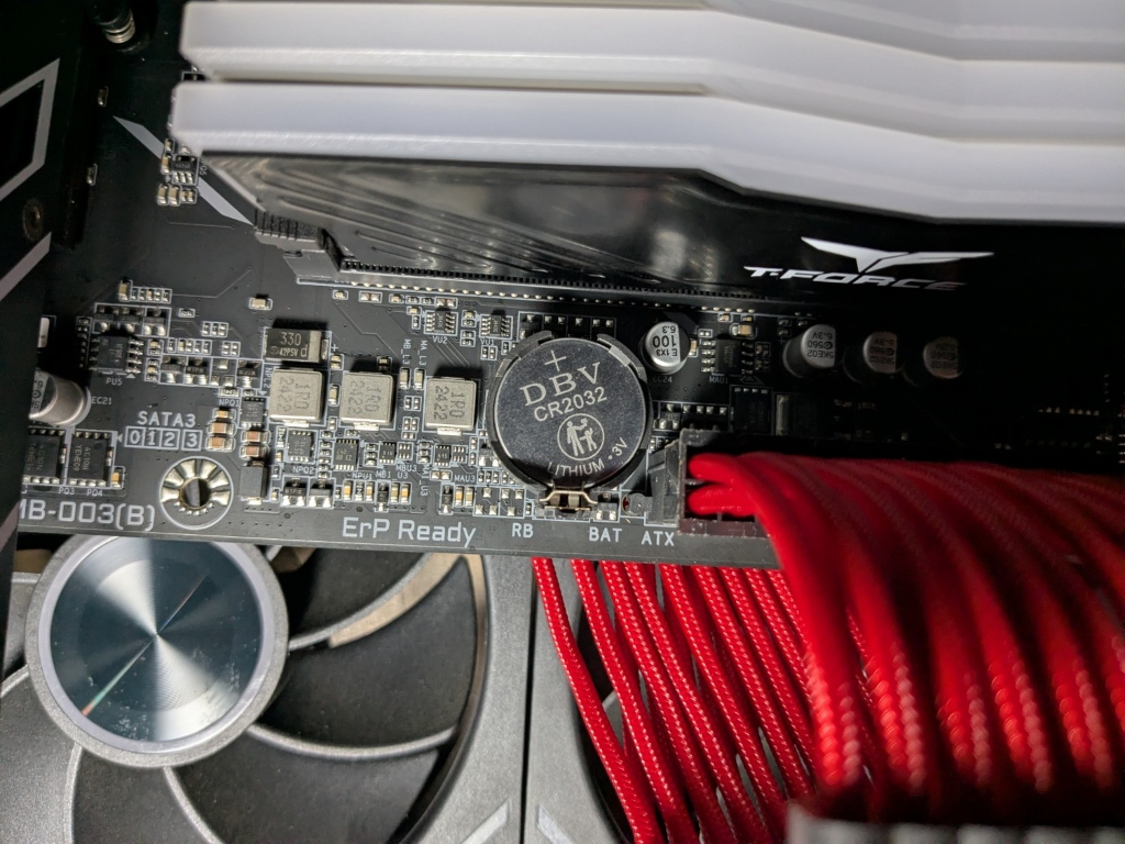 CR2032 silver coin-cell CMOS battery installed on a motherboard