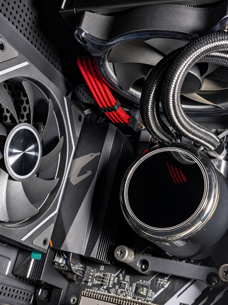 CPU liquid cooler pump block, radiator fans, and motherboard heatsink assembly